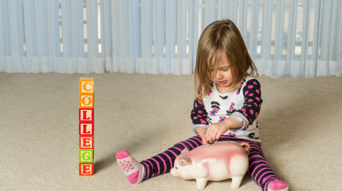 Young Girl On Floor Of Home Saving Money